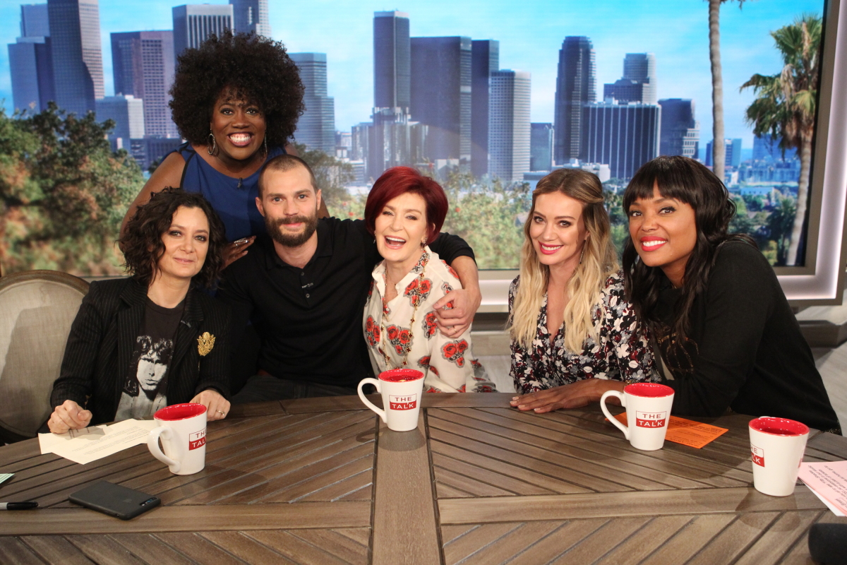 Surprise! Actor Jamie Dornan from "50 Shades Darker" stops by for an unexpected visit with the ladies of "The Talk," Wednesday, February 1, 2017 on the CBS Television Network. From left, Sheryl Underwood, Sara Gilbert, Jamie Dornan, Sharon Osbourne, guest co-host Hilary Duff and Aisha Tyler, shown. Photo: Sonja Flemming/CBS ©2017 CBS Broadcasting, Inc. All Rights Reserved