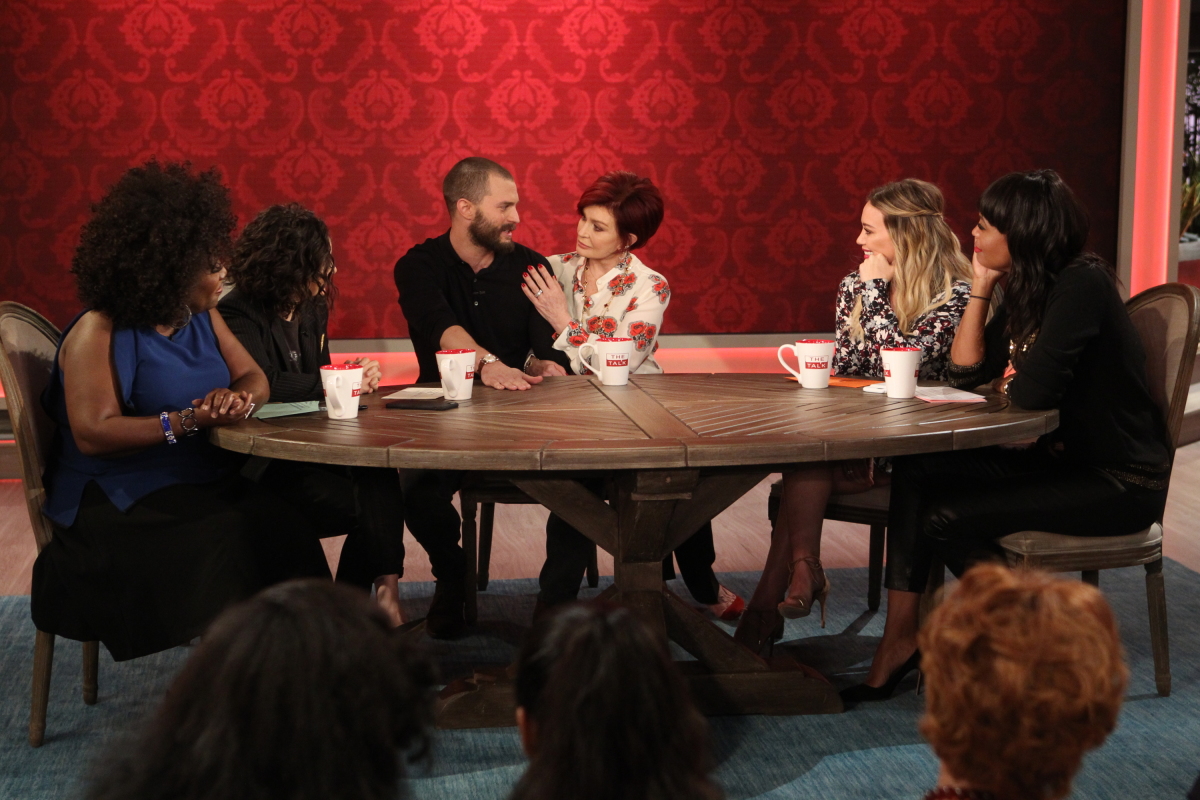 Surprise! Actor Jamie Dornan from "50 Shades Darker" stops by for an unexpected visit with the ladies of "The Talk," Wednesday, February 1, 2017 on the CBS Television Network. From left, Sheryl Underwood, Sara Gilbert, Jamie Dornan, Sharon Osbourne, guest co-host Hilary Duff and Aisha Tyler, shown. Photo: Sonja Flemming/CBS ©2017 CBS Broadcasting, Inc. All Rights Reserved